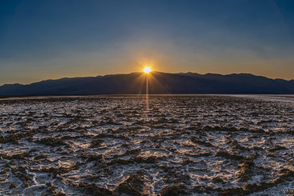 Sunset over the Panamint Range at Badwater Basin salt flats in Death Valley National Park, California.