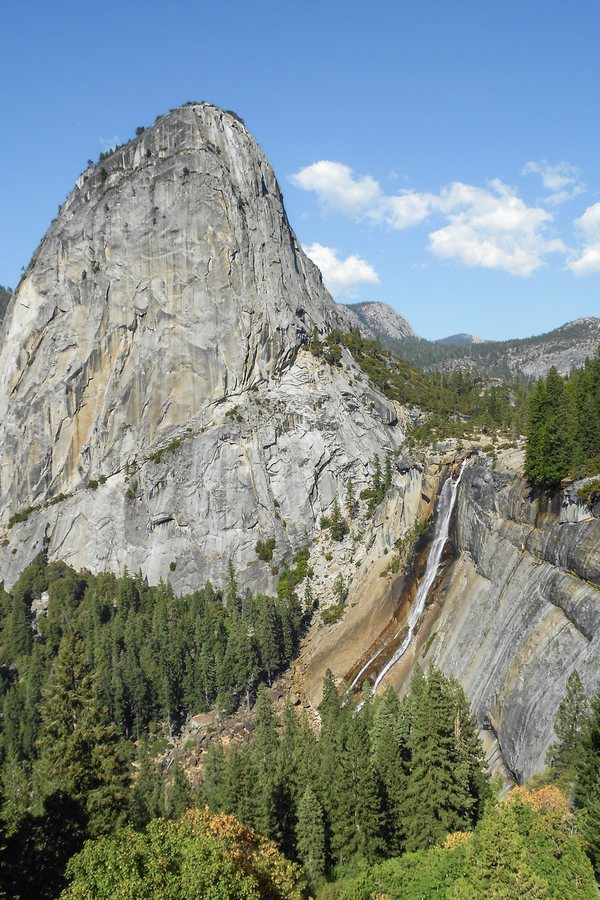 Liberty Cap and Nevada Fall above the forest in Yosemite National Park, California